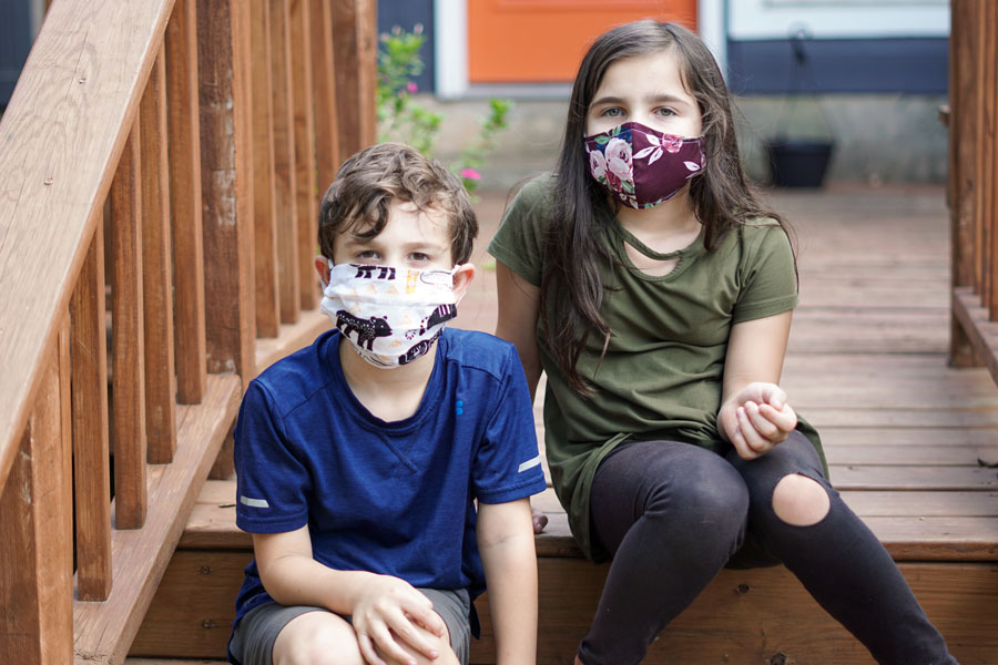 Two children wearing face masks.